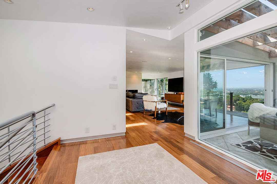 11458 Laurelcrest Road Studio City, CA 91604 - Photo 8 of 30 a living room with furniture and a floor to ceiling window