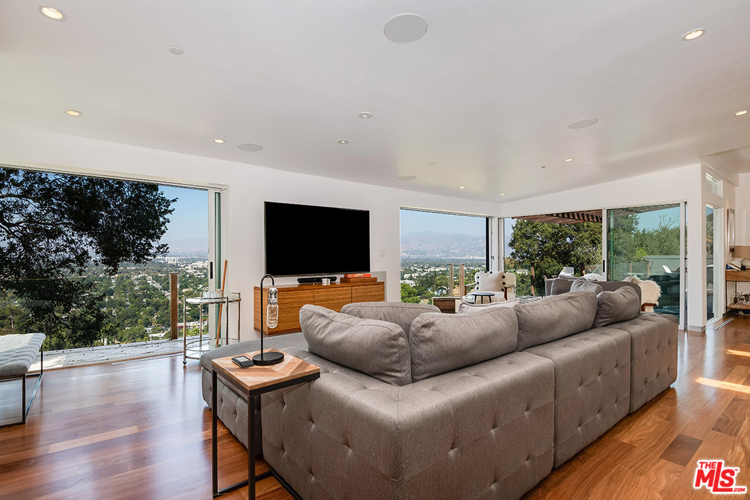 11458 Laurelcrest Road Studio City, CA 91604 - Photo 9 of 30 a living room with furniture a flat screen tv and a large window