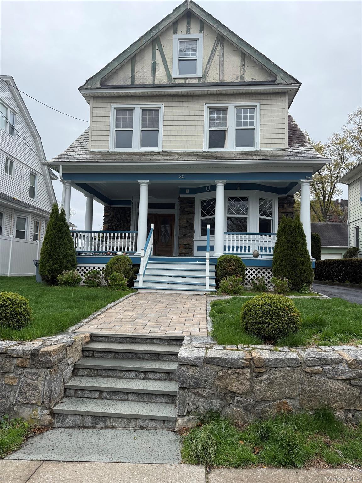 a front view of a house with a garden