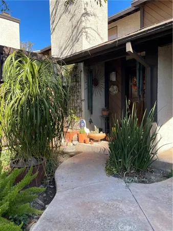 a view of a path along with potted plants