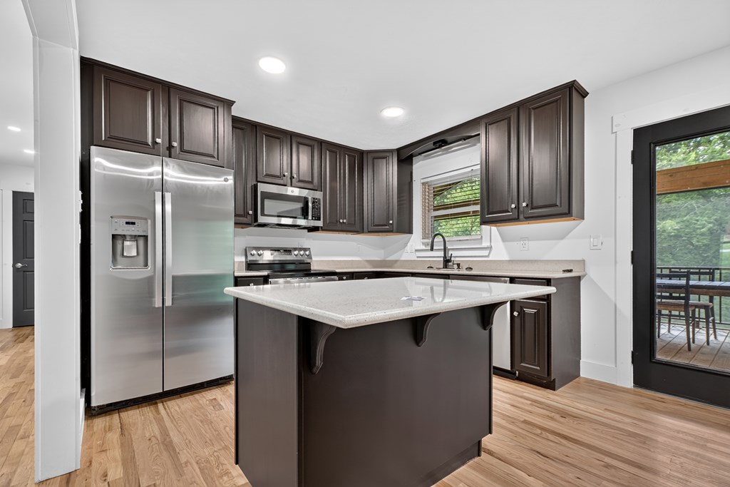 975 Goss Road Epworth, GA 30541 - Photo 47 of 58 a kitchen with kitchen island granite countertop stainless steel appliances cabinets a sink and a counter space