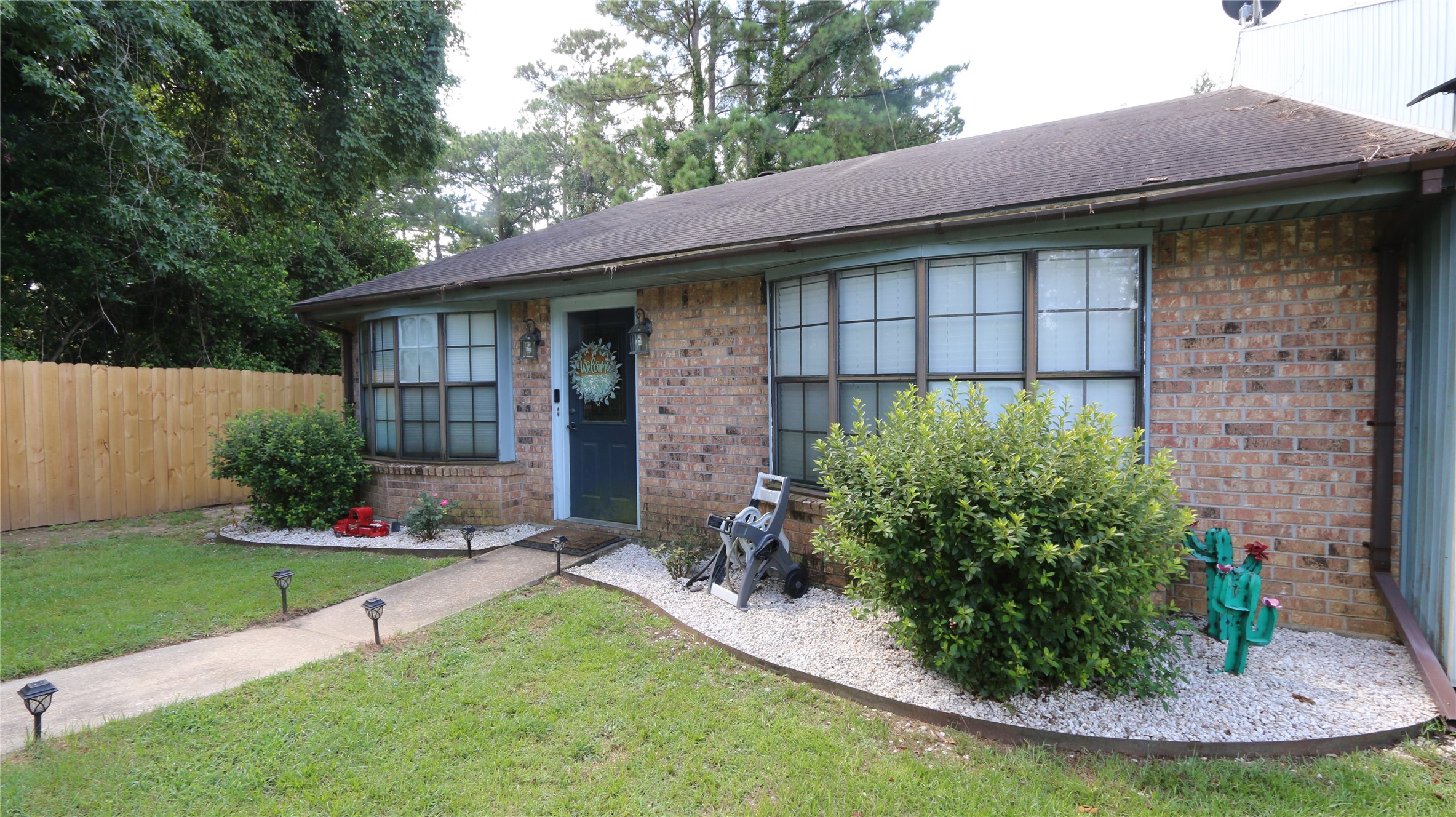 a view of a house with a yard and plants