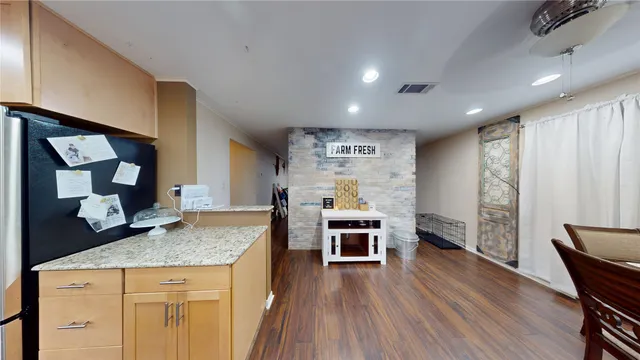 a kitchen with granite countertop a stove and a wooden floors