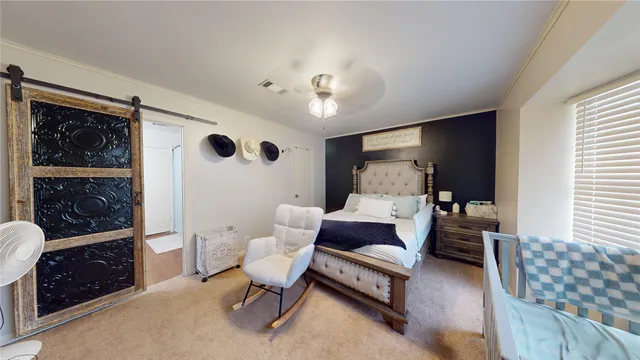 a bedroom with furniture and a window