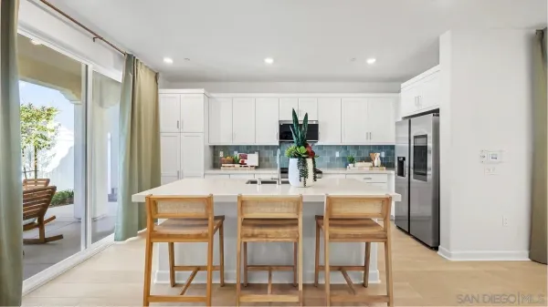 a kitchen with kitchen island and stainless steel appliances