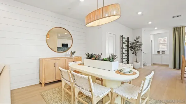 a view of a dining room with furniture and a chandelier