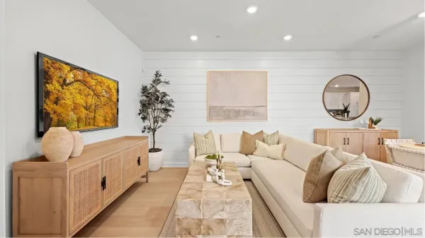 a living room with furniture flowerpot and window