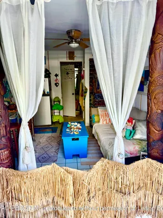 a view of a house with a yard and potted plants
