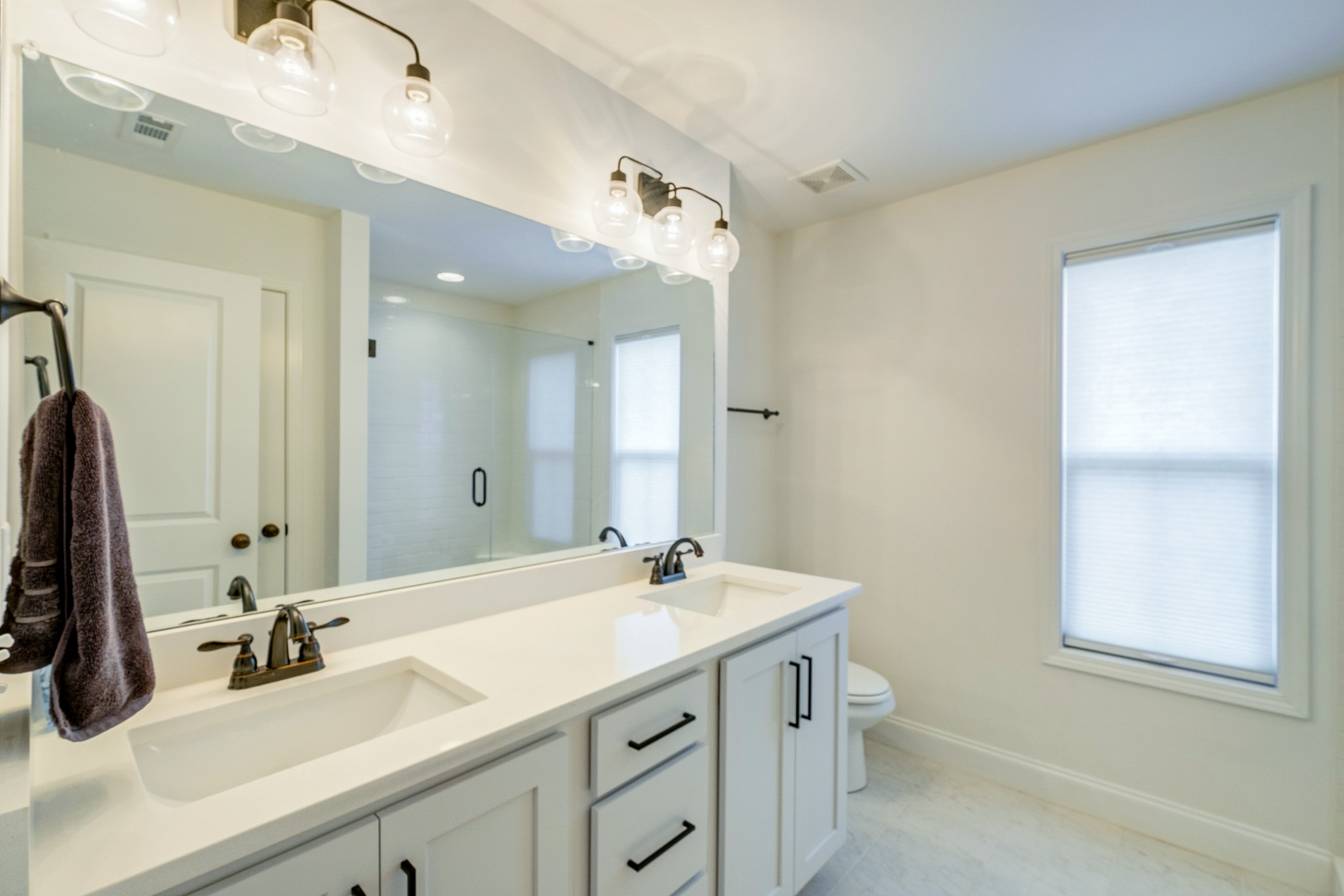 347 Preakness Circle Pleasant View, TN 37146 - Photo 14 of 29 a bathroom with a double vanity sink a mirror and a shower