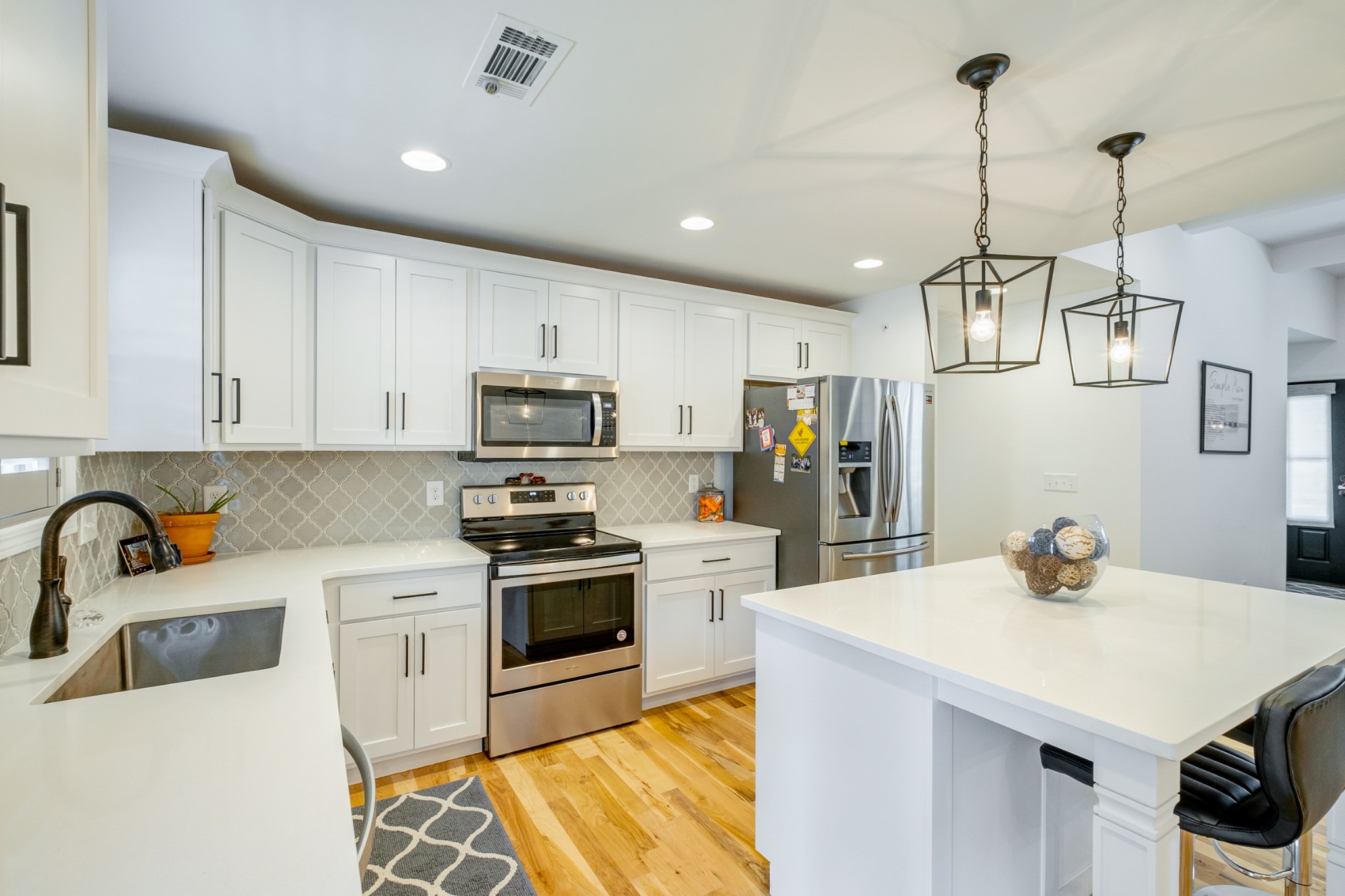 347 Preakness Circle Pleasant View, TN 37146 - Photo 4 of 29 a kitchen with stainless steel appliances a sink a stove a refrigerator cabinets and living room view