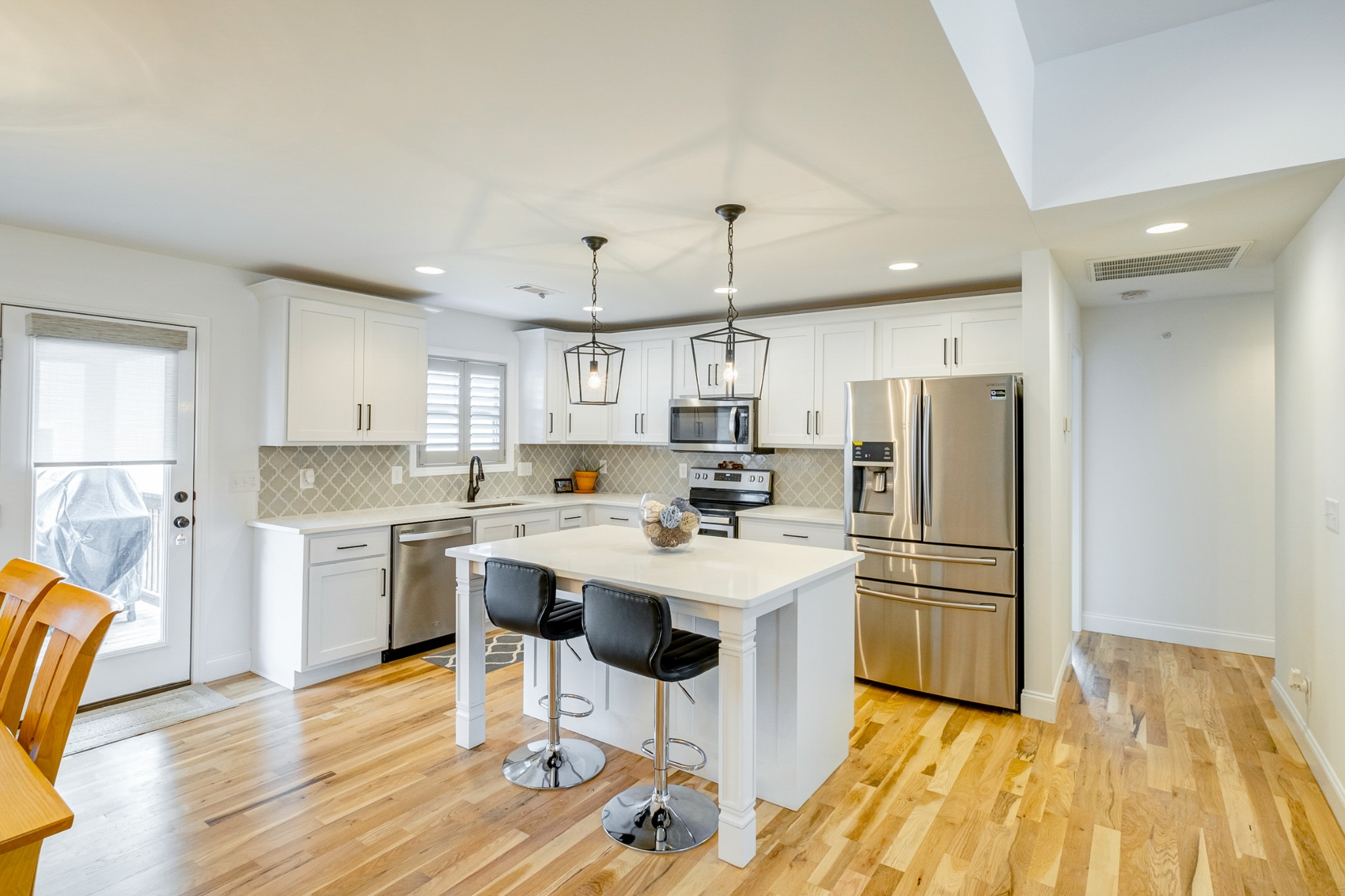 347 Preakness Circle Pleasant View, TN 37146 - Photo 5 of 29 a kitchen with stainless steel appliances a stove a sink dishwasher a refrigerator white cabinets and wooden floor