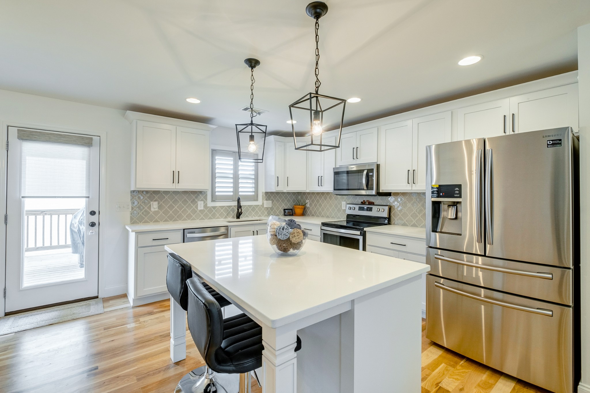 347 Preakness Circle Pleasant View, TN 37146 - Photo 6 of 29 a kitchen with a refrigerator a sink dishwasher a stove and white cabinets with wooden floor