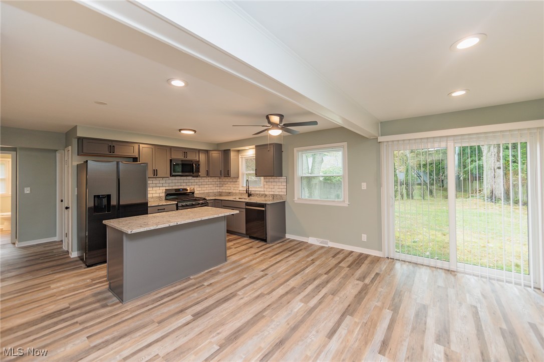 952 Murray Road South Euclid, OH 44121 - Photo 4 of 30 Kitchen featuring stainless steel appliances, light hardwood / wood-style floors, a kitchen island, and ceiling fan