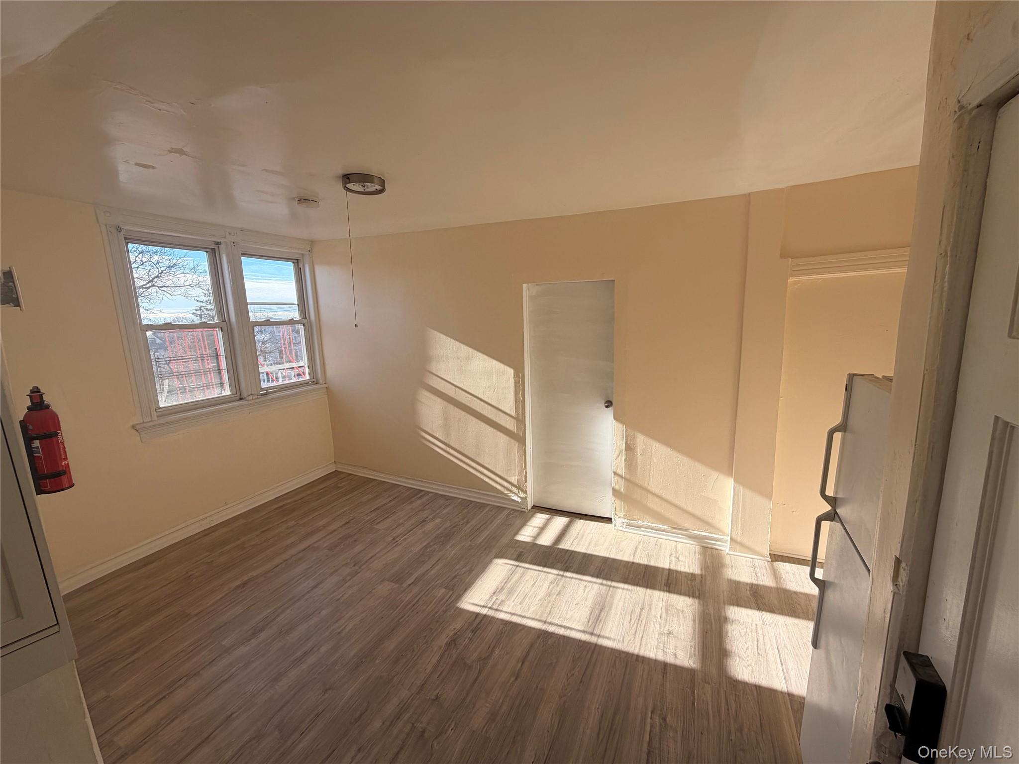 315 South 4th Avenue, Unit 3 Mount Vernon, NY 10550 - Photo 4 of 10 an empty room with wooden floor and windows