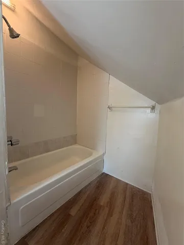 a bathroom with a bathtub and shower