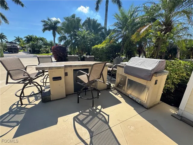 a view of a patio with table and chairs with wooden floor and fence