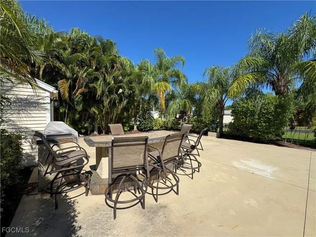 a view of a patio with table and chairs and potted plants with sky view