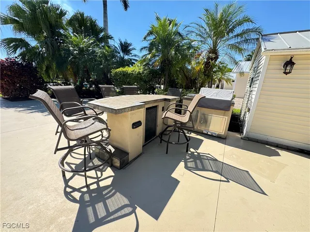 a view of a patio with table and chairs and potted plants with wooden floor