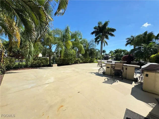 a view of a swimming pool with a chair and tables in the patio