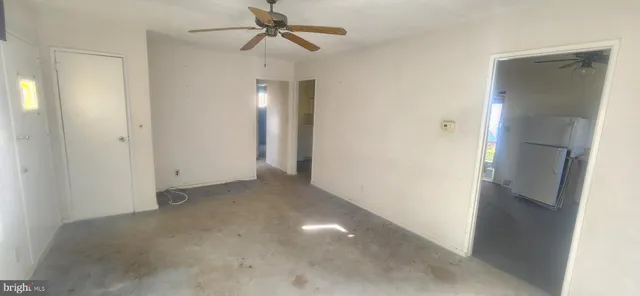 a view of a hallway with a chandelier fan