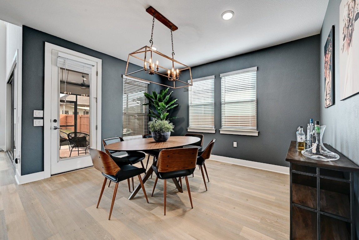 8509 Silverthorne Street Austin, TX 78744 - Photo 13 of 39 a dining room with a wooden table and chairs