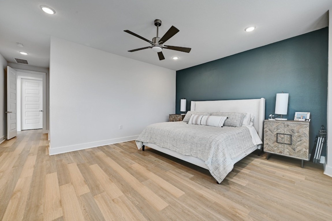 8509 Silverthorne Street Austin, TX 78744 - Photo 16 of 39 a bedroom with a bed and a chandelier