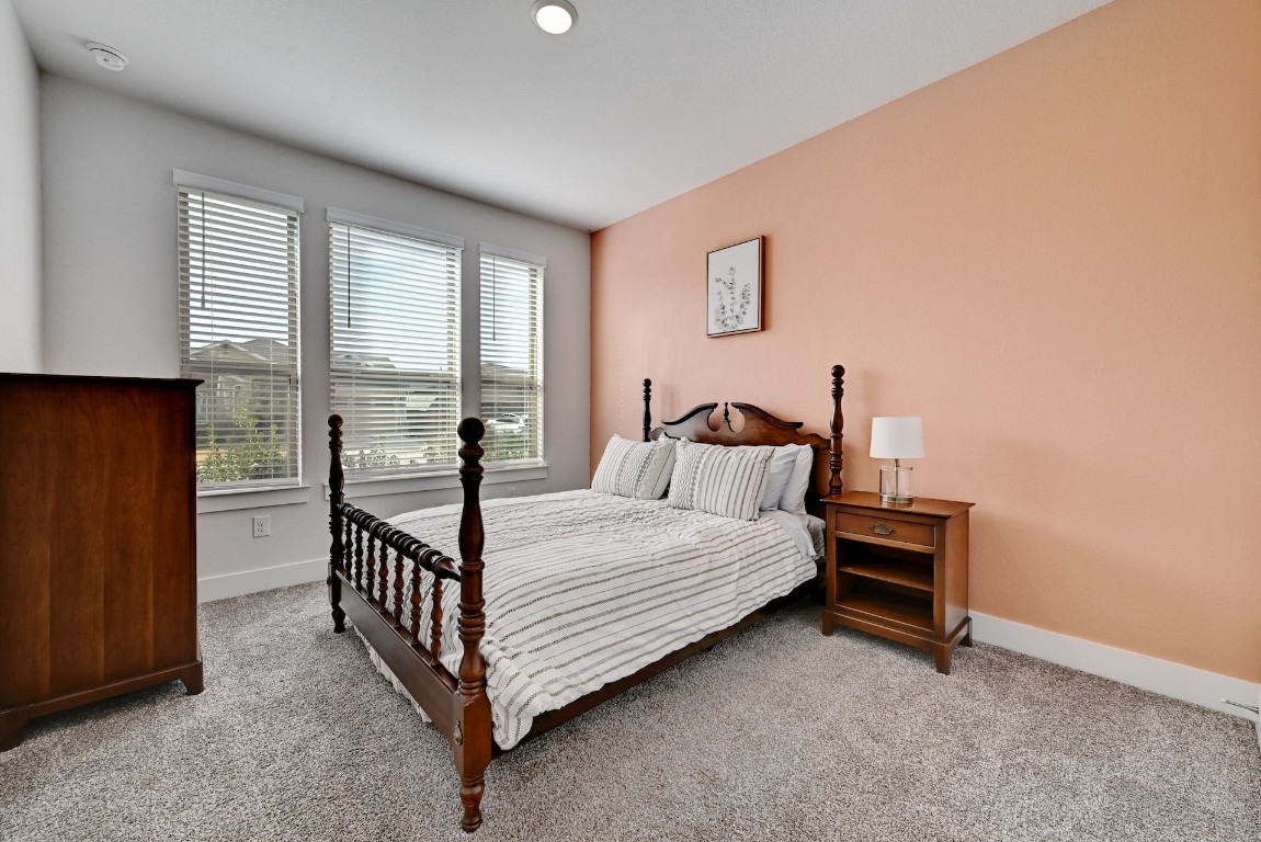 8509 Silverthorne Street Austin, TX 78744 - Photo 23 of 39 a bed room with a bed and a window