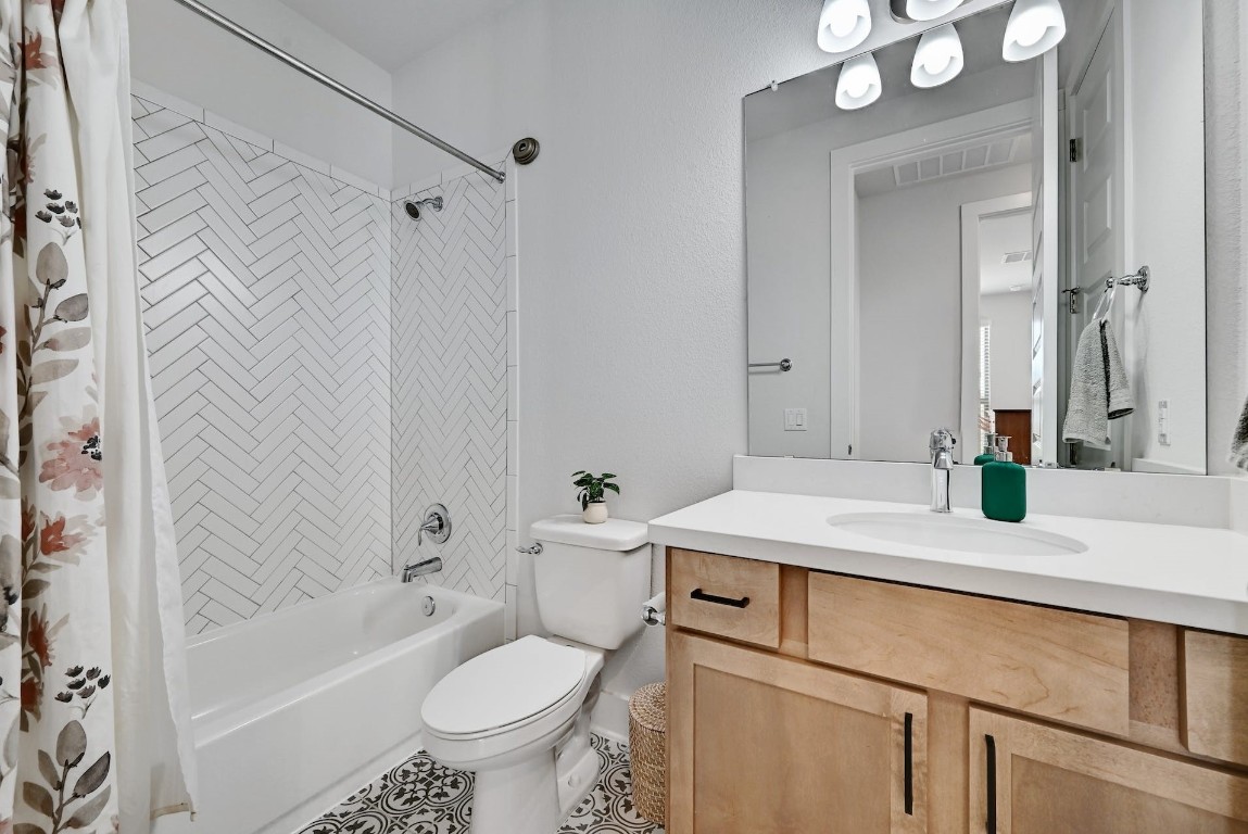 8509 Silverthorne Street Austin, TX 78744 - Photo 24 of 39 a bathroom with a sink a toilet and shower