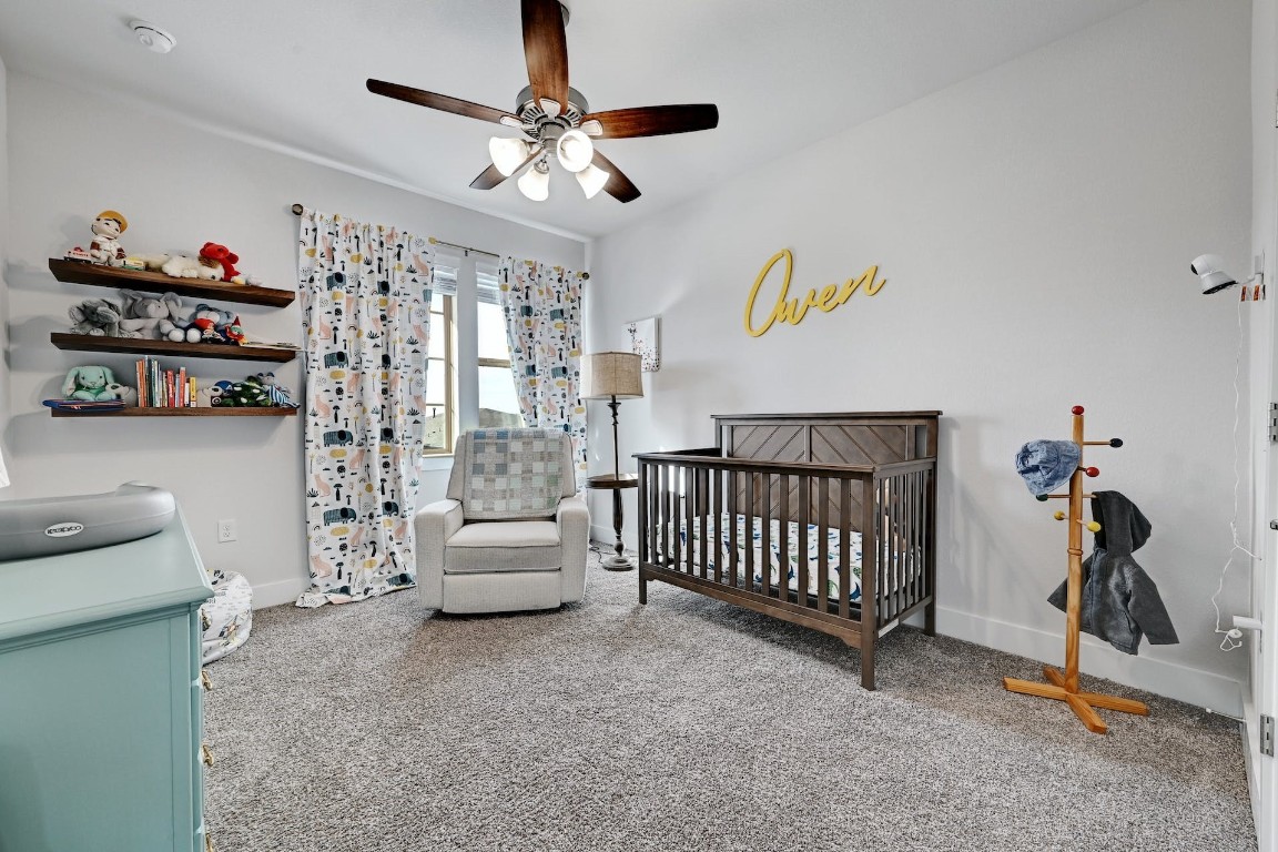 8509 Silverthorne Street Austin, TX 78744 - Photo 25 of 39 a bedroom with furniture and a chandelier