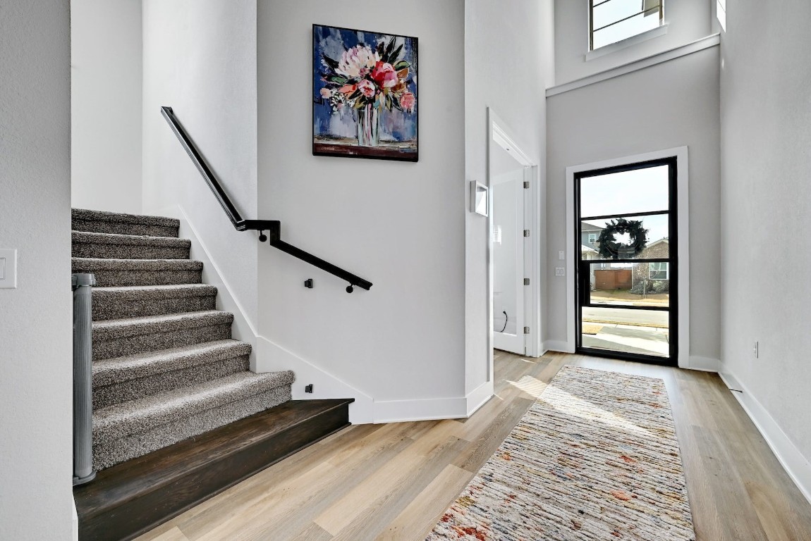 8509 Silverthorne Street Austin, TX 78744 - Photo 27 of 39 a view of a hallway with wooden floor and staircase