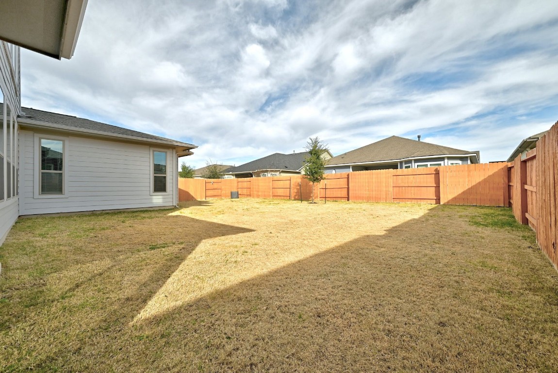 8509 Silverthorne Street Austin, TX 78744 - Photo 30 of 39 a view of house with backyard