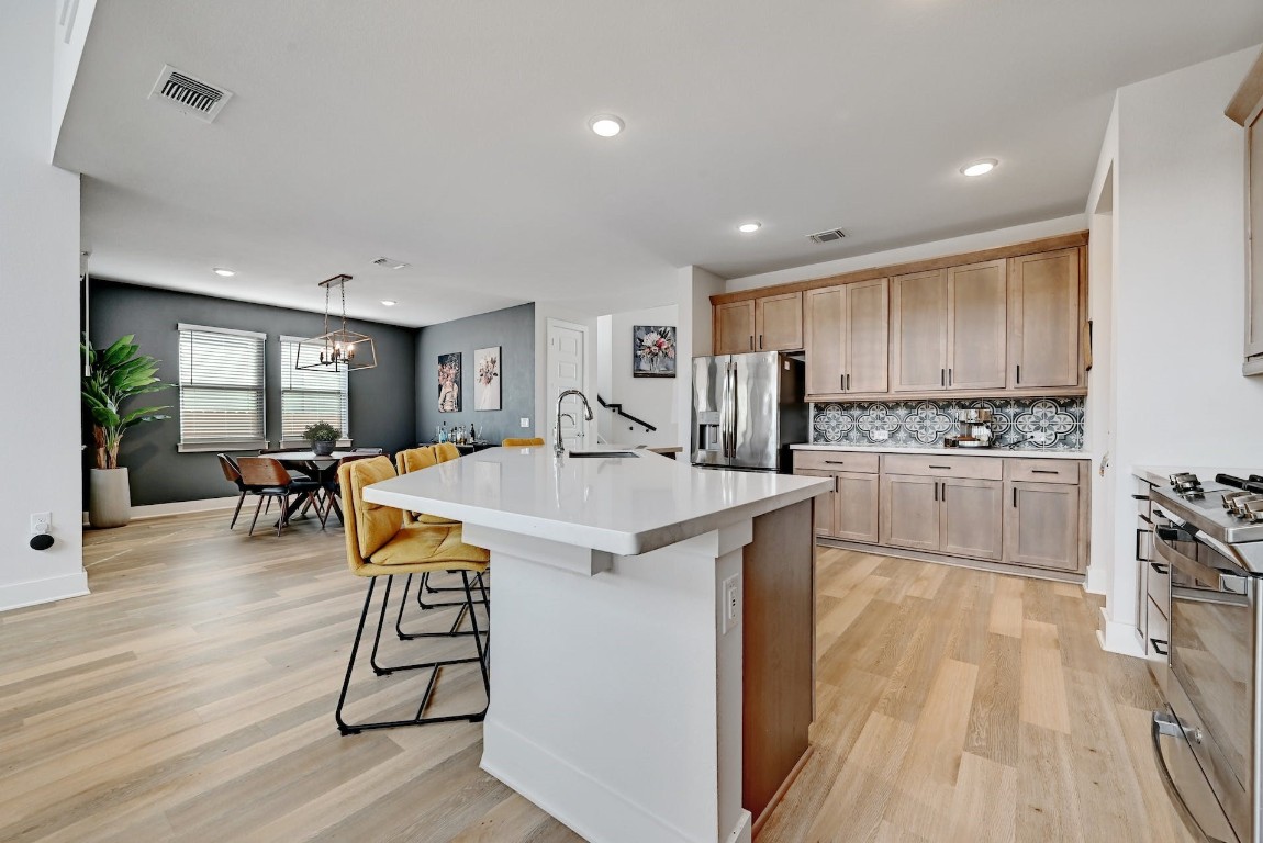 8509 Silverthorne Street Austin, TX 78744 - Photo 6 of 39 a kitchen with counter top space a sink appliances and cabinets