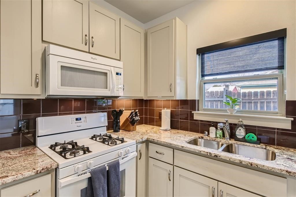 2012 Willow Street, Unit B Austin, TX 78702 - Photo 5 of 15 a kitchen with granite countertop a sink stove and cabinets