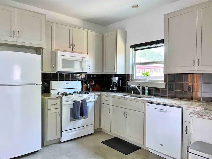 2012 Willow Street, Unit B Austin, TX 78702 - Photo 6 of 15 a kitchen with white cabinets and white appliances