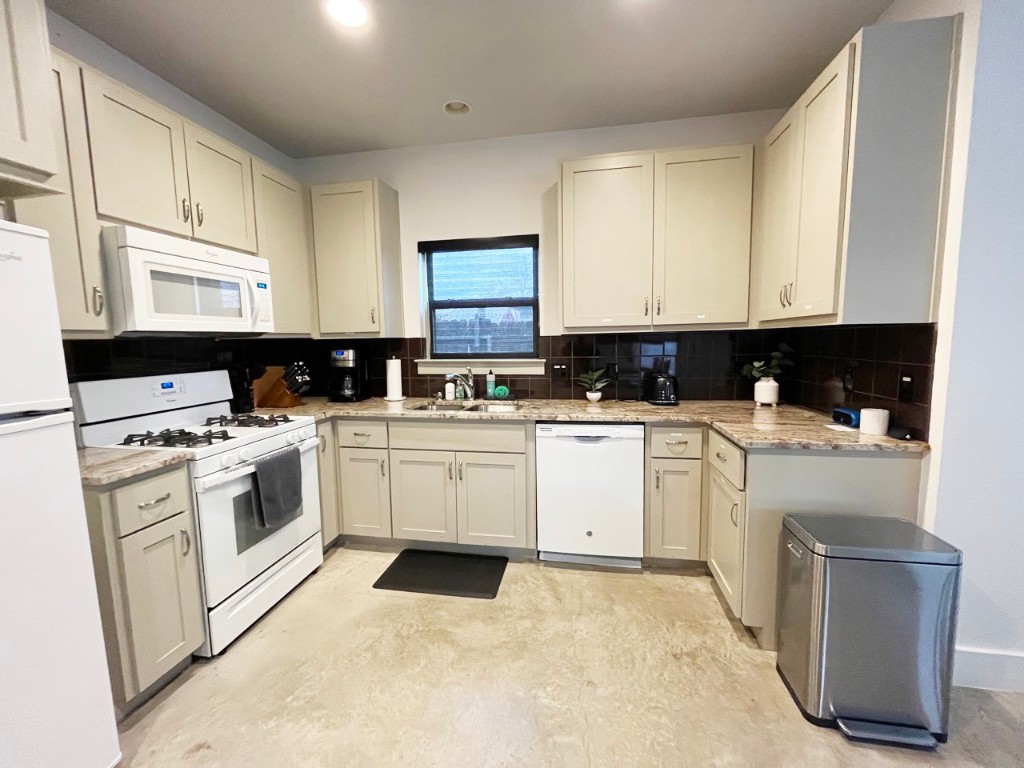 2012 Willow Street, Unit B Austin, TX 78702 - Photo 8 of 15 a kitchen with white cabinets sink and white appliances