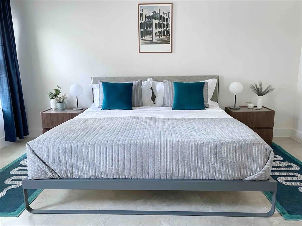 2012 Willow Street, Unit B Austin, TX 78702 - Photo 10 of 15 a bedroom with a bed and painting on the wall