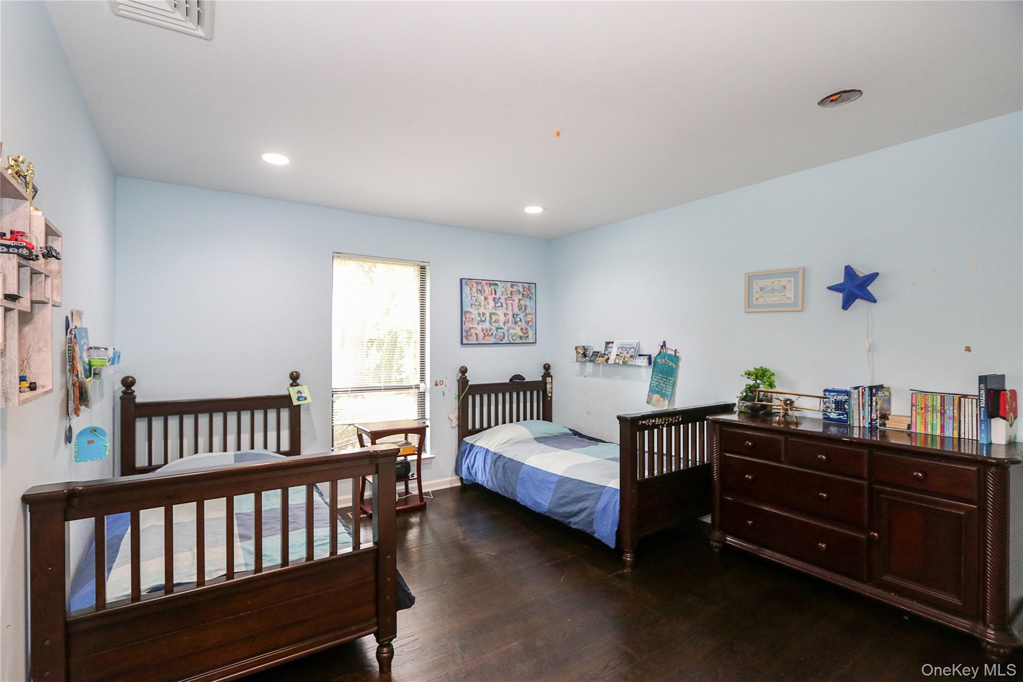 35 Old Pond Road Great Neck, NY 11023 - Photo 13 of 21 a bedroom with two beds and wooden floor