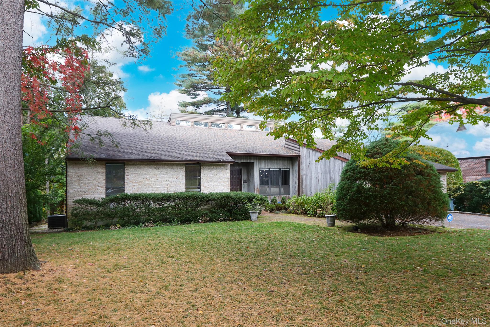 35 Old Pond Road Great Neck, NY 11023 - Photo 2 of 21 a front view of a house with a garden