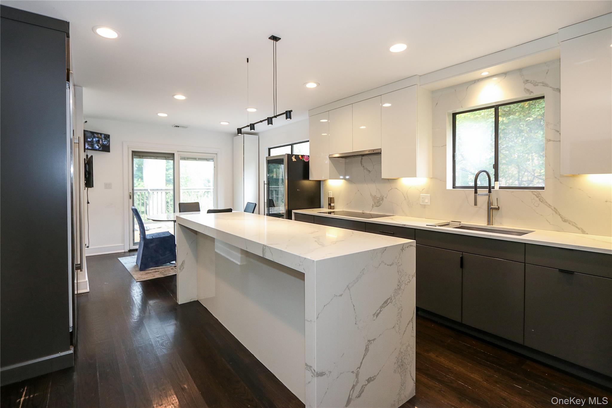 35 Old Pond Road Great Neck, NY 11023 - Photo 9 of 21 a large kitchen with a large counter top a sink stainless steel appliances and cabinets