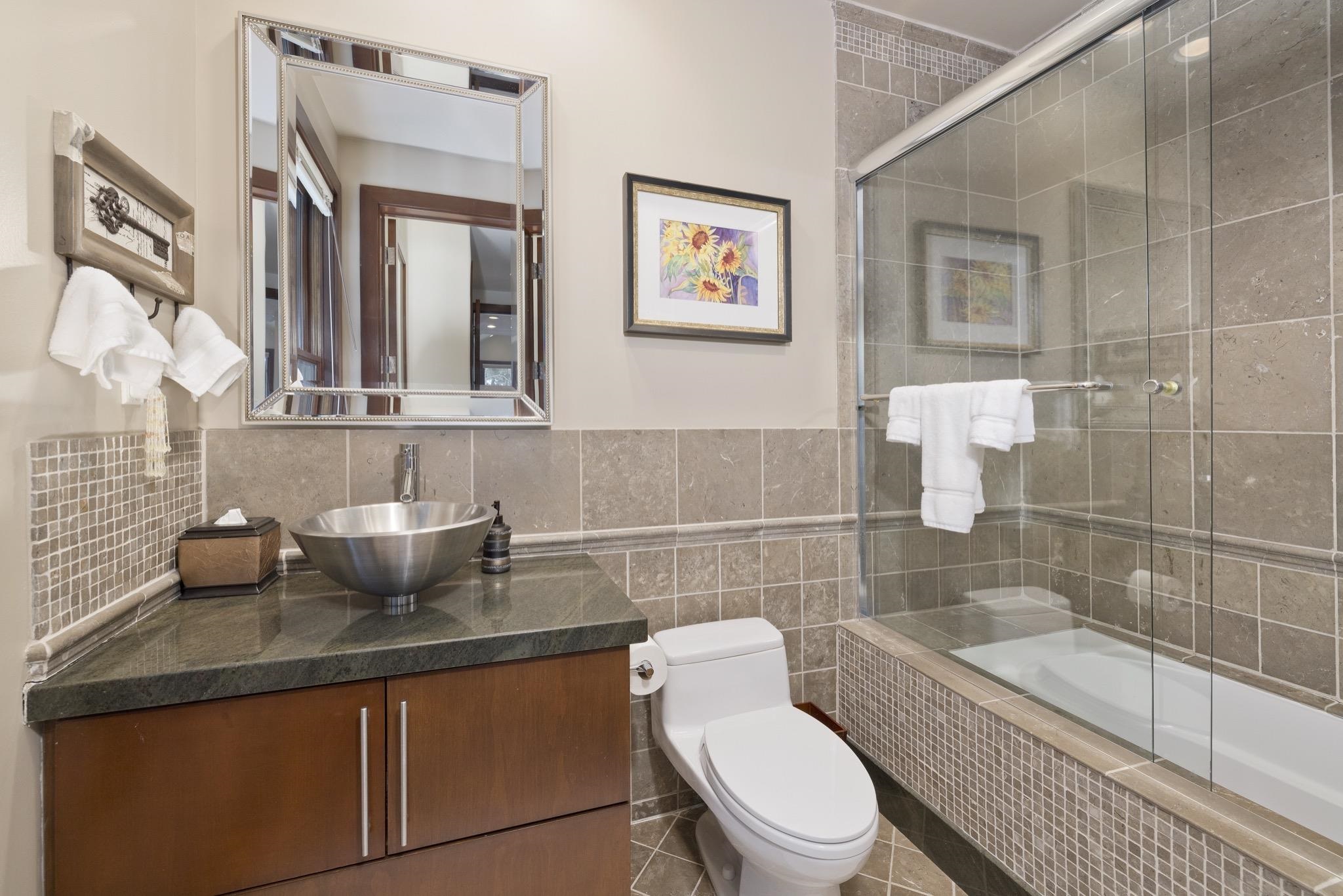 310 Ranch Road Mammoth Lakes, CA 93546 - Photo 23 of 40 Bathroom with tiled shower / bath, vanity, tile walls, and tile patterned flooring