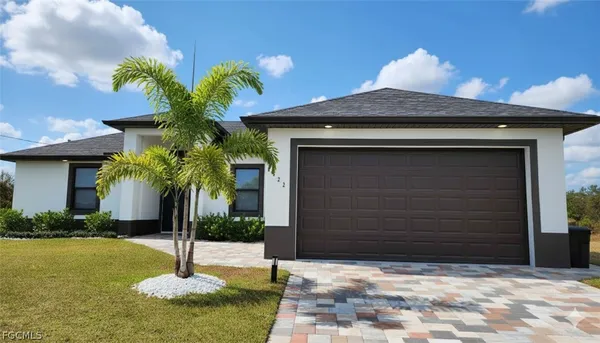 a house with a yard and potted plants