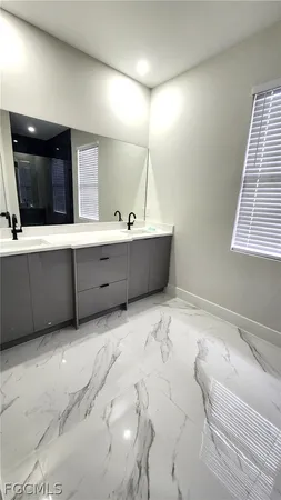 a bathroom with a tub sink and mirror