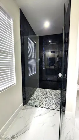 a bathroom with a bathtub and a shower