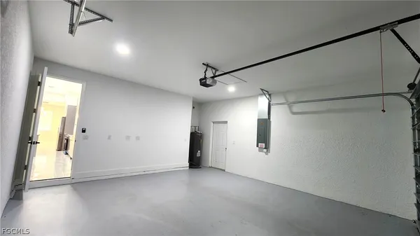 a view of a big room with wooden floor and windows