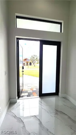 a view of a room that has a large window and a yard