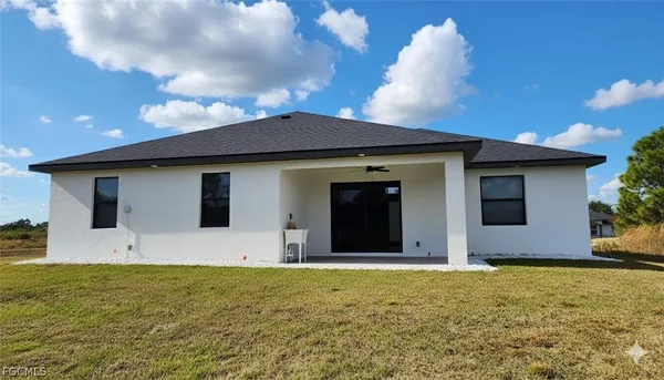 a house view with swimming pool in front of it