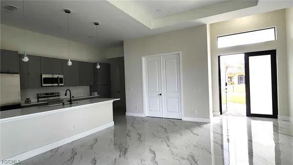 a kitchen with stainless steel appliances a sink a stove and a refrigerator