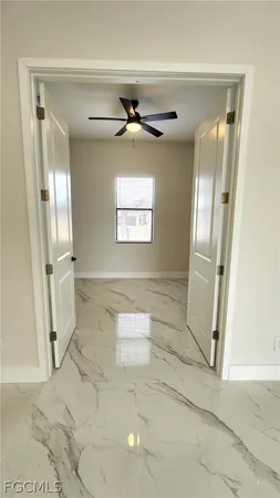 a view of a hallway with windows and entryway