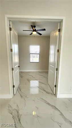 a view of a hallway with windows and entryway