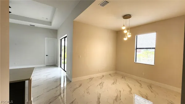 a view of empty room with a ceiling fan and window